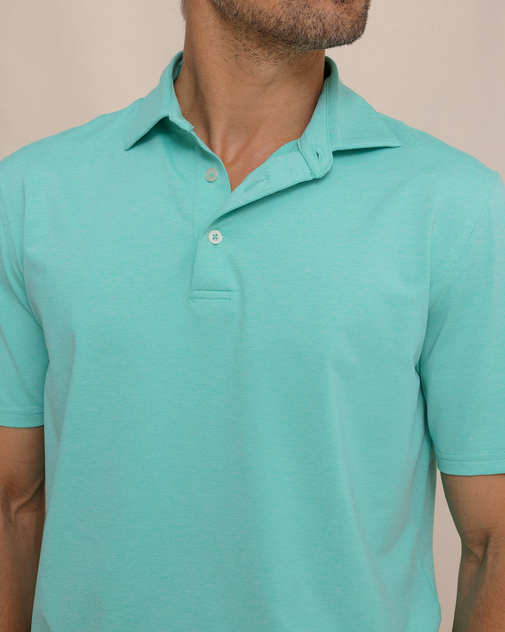 The detail view of the Southern Tide brrr°®-eeze Heather Performance Polo Shirt by Southern Tide - Heather Turtle Green