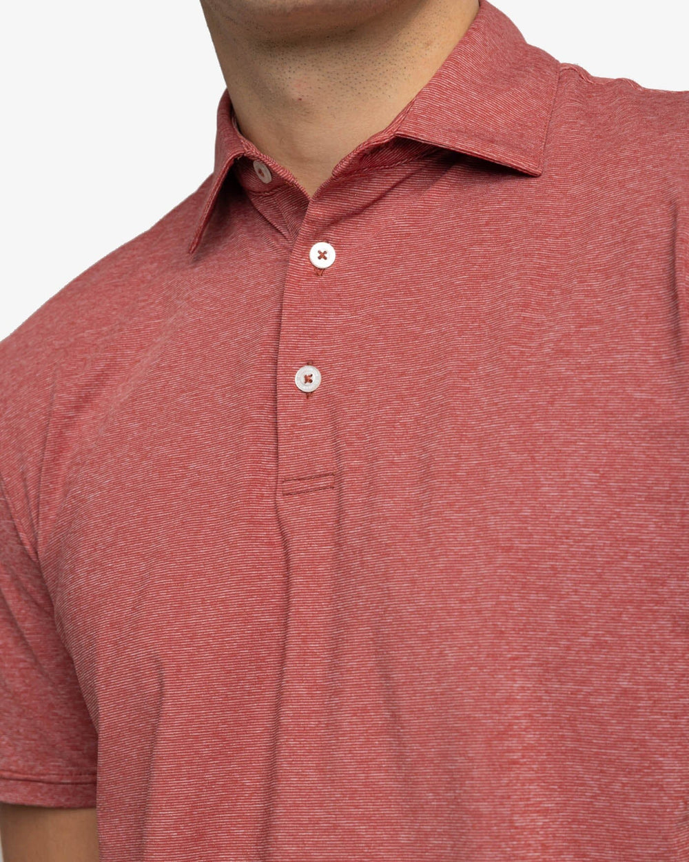 The detail view of the Southern Tide brrr-eeze Heather Performance Polo Shirt by Southern Tide - Heather Tuscany Red