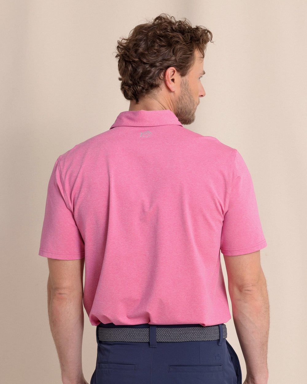 The back view of the Southern Tide brrr°®-eeze Heather Performance Polo Shirt by Southern Tide - Heather Very Berry