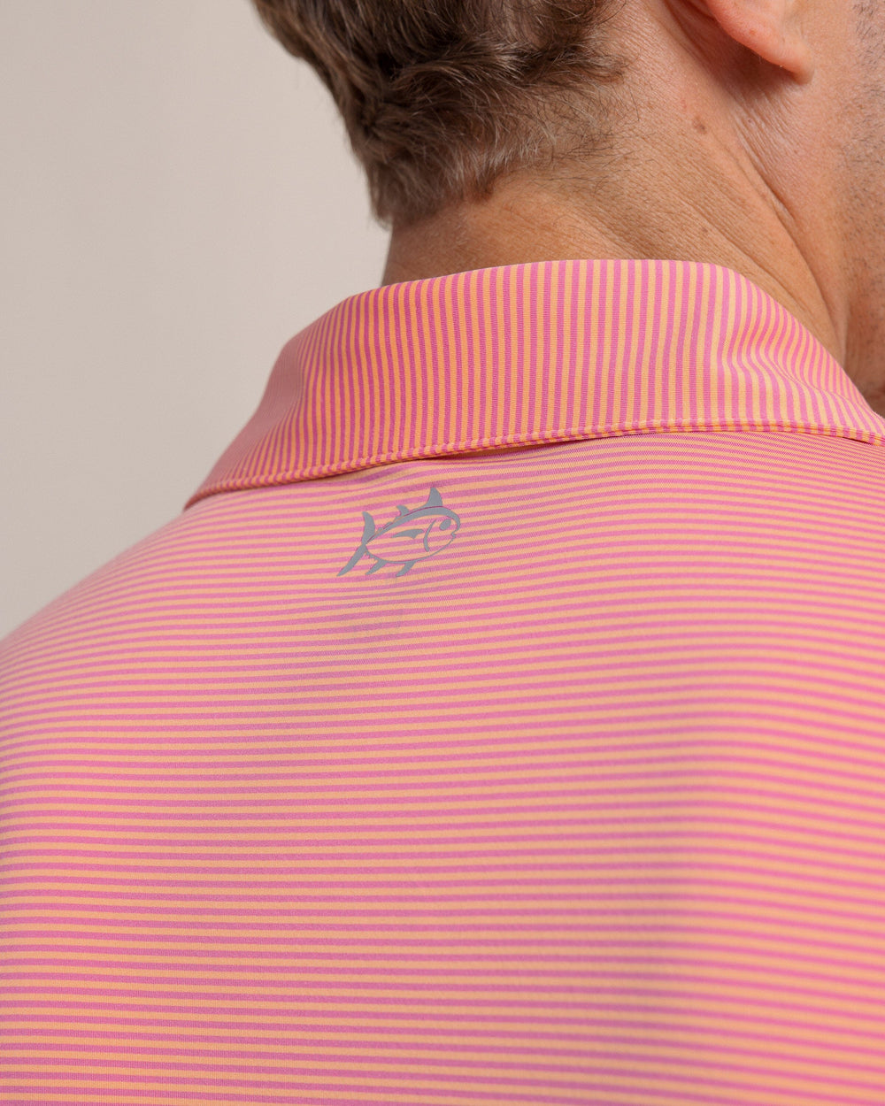 The back detail view of the Southern Tide brrr-eeze Meadowbrook Stripe Polo by Southern Tide - Cantaloupe