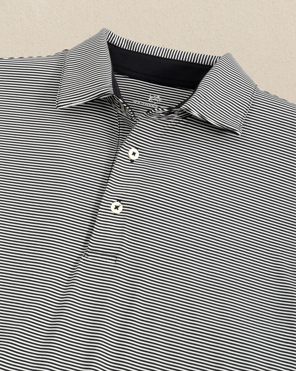 The detail view of the Southern Tide brrr-eeze Meadowbrook Stripe Polo by Southern Tide - Caviar Black