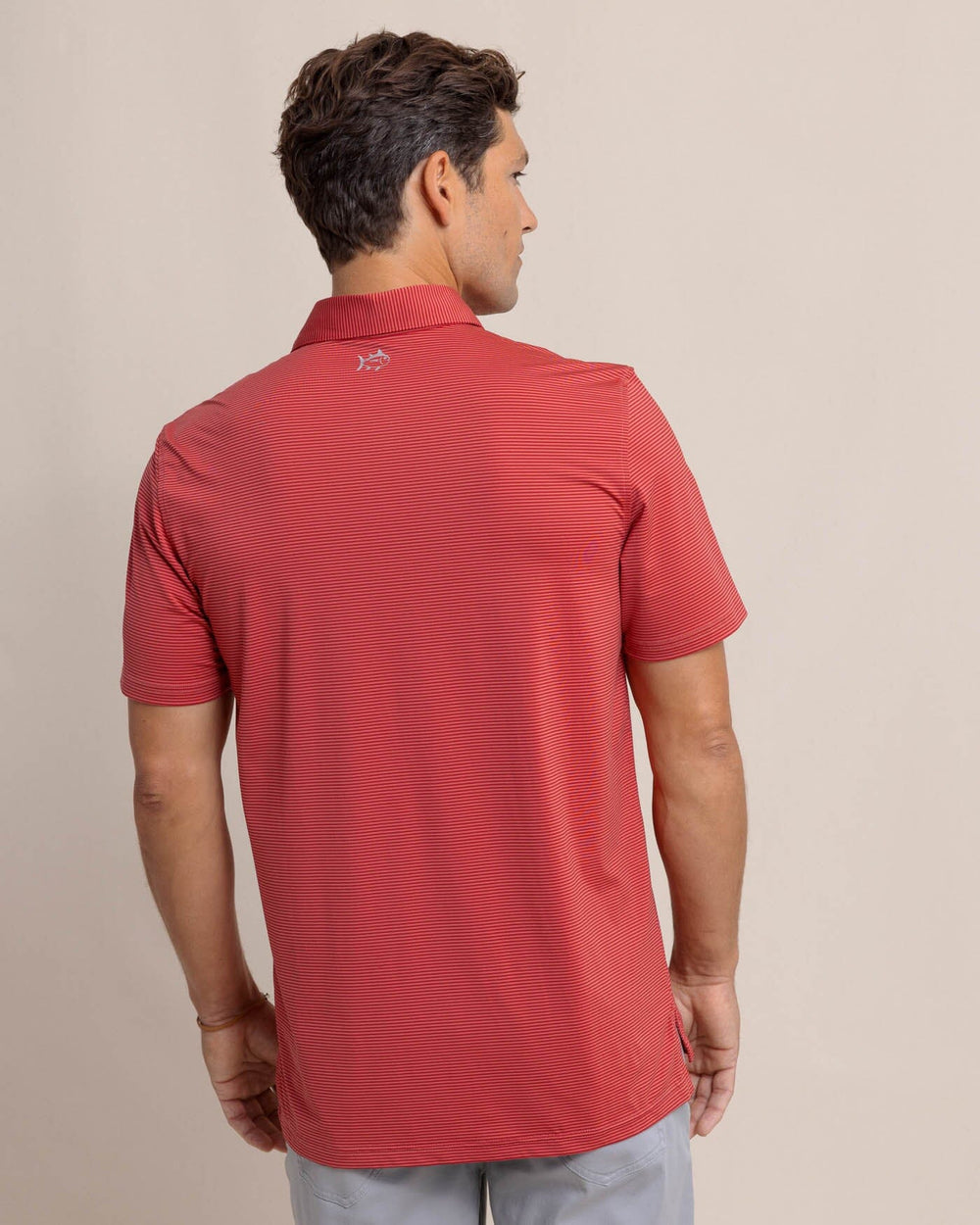 The back view of the Southern Tide brrr-eeze Meadowbrook Stripe Polo by Southern Tide - Mineral Red