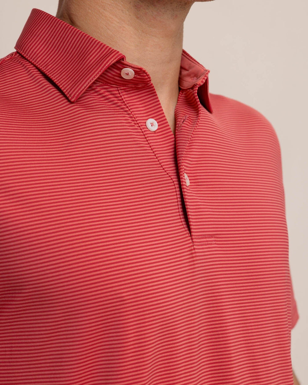 The detail view of the Southern Tide brrr-eeze Meadowbrook Stripe Polo by Southern Tide - Mineral Red