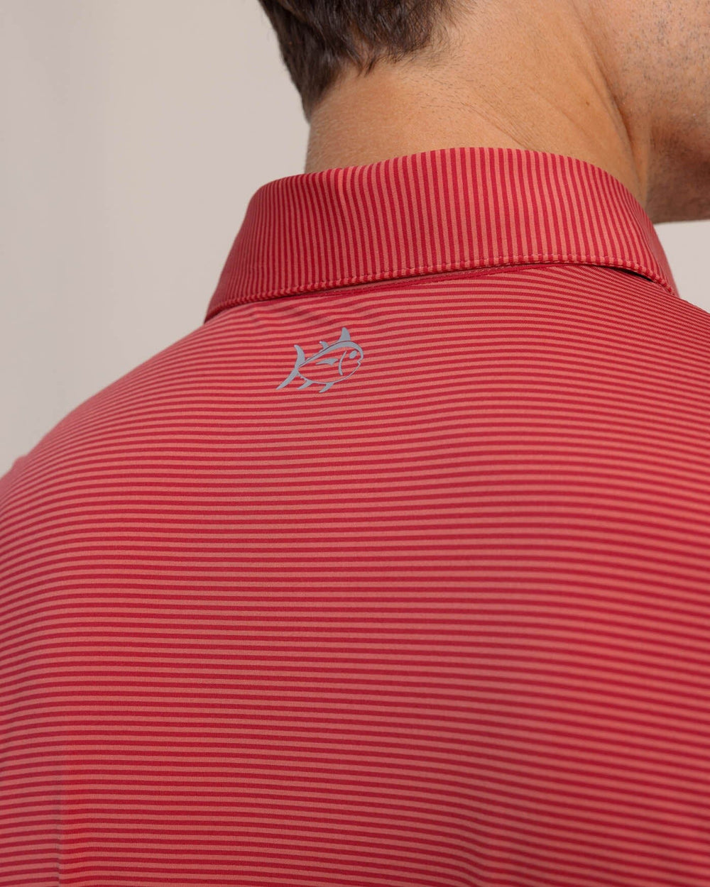 The detail view of the Southern Tide brrr-eeze Meadowbrook Stripe Polo by Southern Tide - Mineral Red