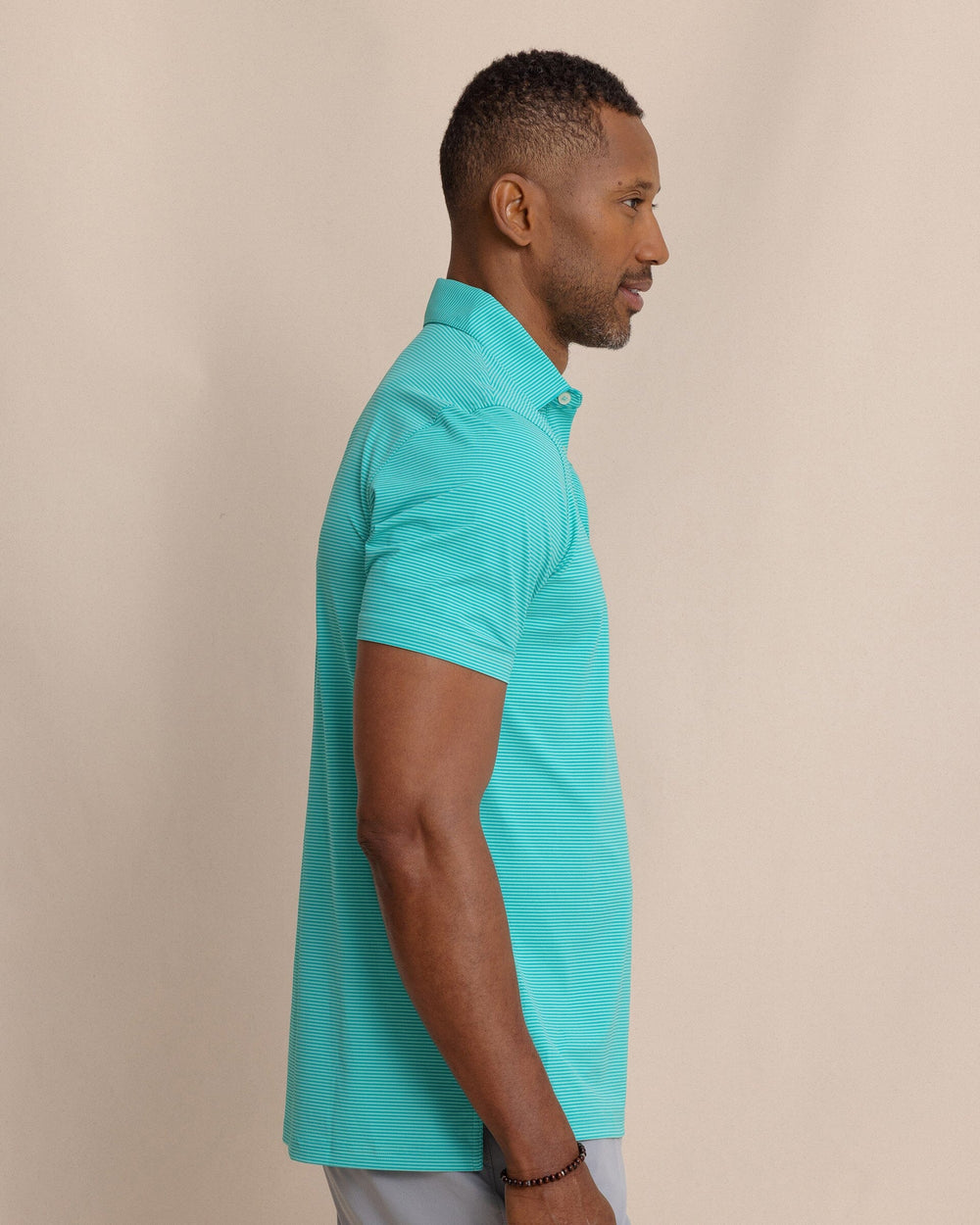 The side view of the Southern Tide brrr°®-eeze Meadowbrook Stripe Polo by Southern Tide - Turtle Green