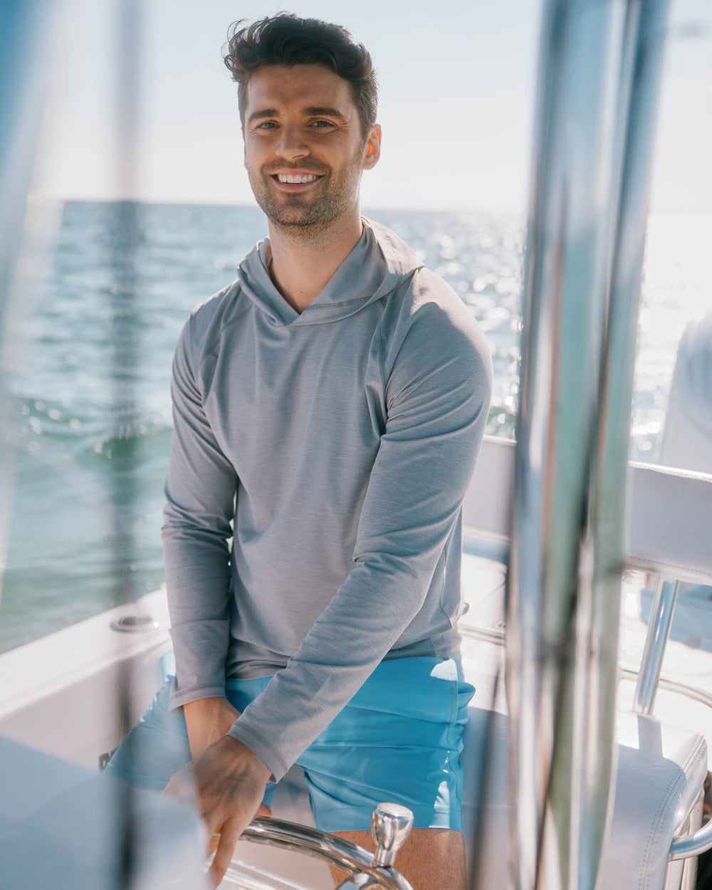 The lifestyle view of the Southern Tide brrr°®-illiant Performance Hoodie by Southern Tide - Steel Grey