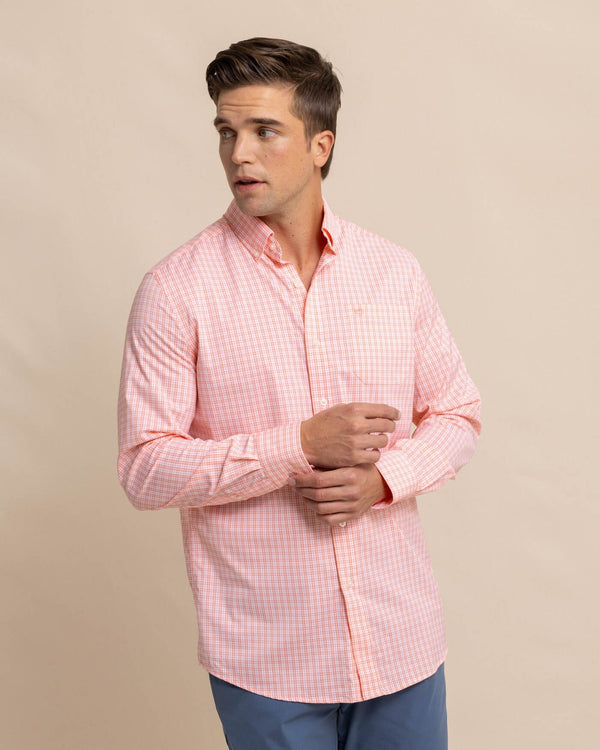 The front view of the Southern Tide brrr Intercoastal Poinsett Plaid Long Sleeve Sport Shirt by Southern Tide - Desert Flower Coral
