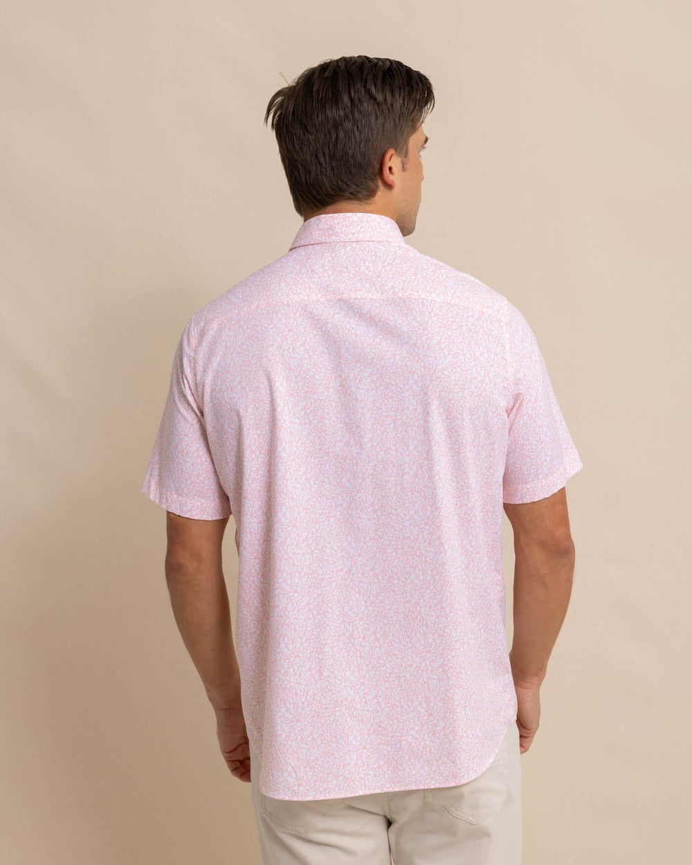 The back view of the Southern Tide brrr Intercoastal That Floral Feeling Short Sleeve Sport Shirt by Southern Tide - Apricot Blush Coral