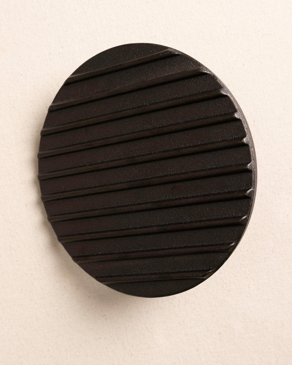 The bottom view of the Burger Master Cast Iron Grill Press at Southern Tide - Natural