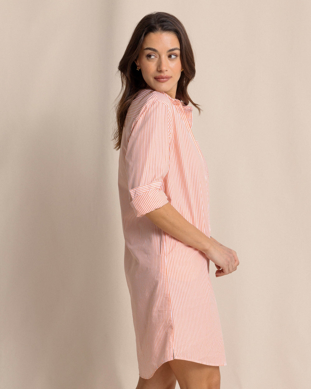 The side view of the Southern Tide Cam Stripe Poplin Dress by Southern Tide - Peach Parfait