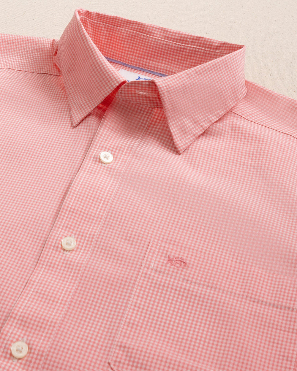 The detail view of the Southern Tide Charleston Parkwood Microgingham Long Sleeve Sport Shirt by Southern Tide - Sunkist Coral