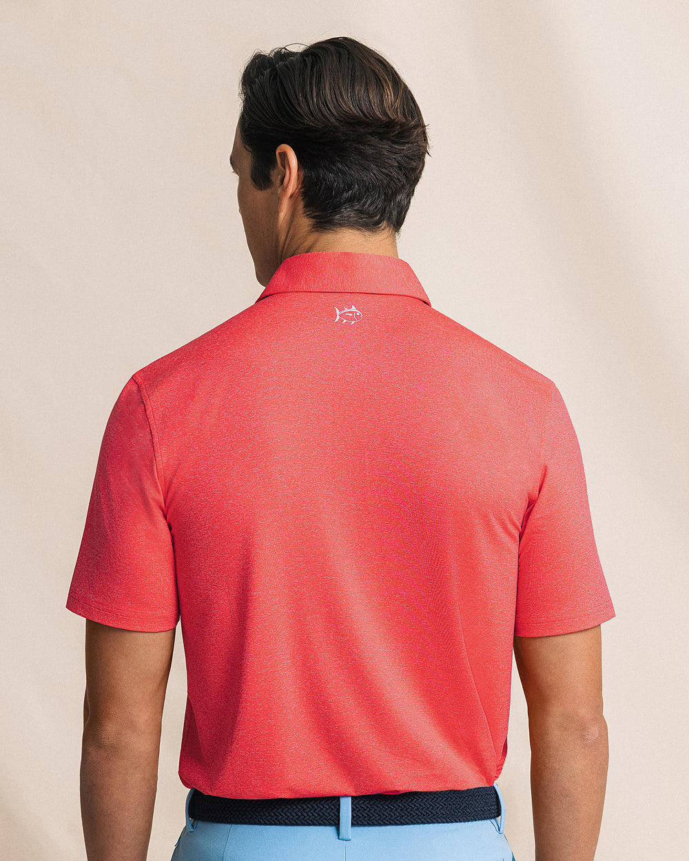 The back view of the Southern Tide Coastal Breeze® Heather Performance Polo by Southern Tide - Heather Channel Marker Red