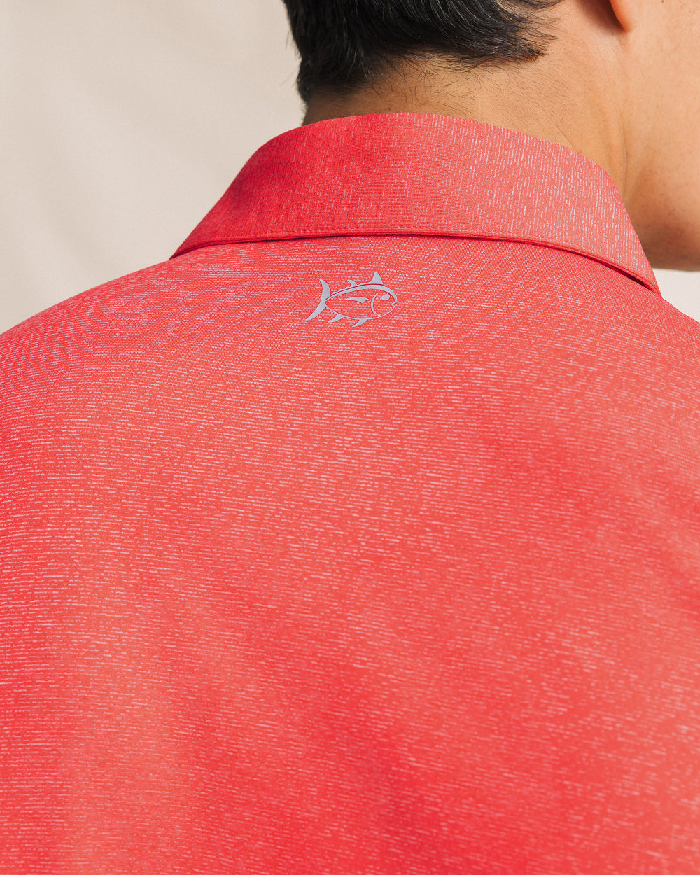 The detail view of the Southern Tide Coastal Breeze® Heather Performance Polo by Southern Tide - Heather Channel Marker Red