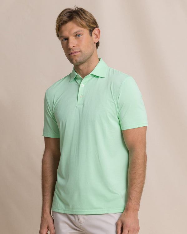 The front view of the Southern Tide Coastal Breeze® Heather Performance Polo by Southern Tide - Heather Green Ash