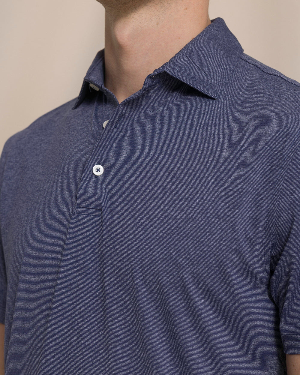 The detail view of the Southern Tide Coastal Breeze® Heather Performance Polo by Southern Tide - Heather Nautical Navy