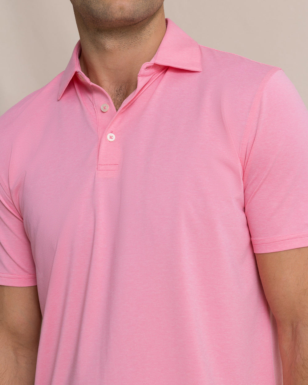 The detail view of the Southern Tide Coastal Breeze® Heather Performance Polo by Southern Tide - Heather Sea Pink