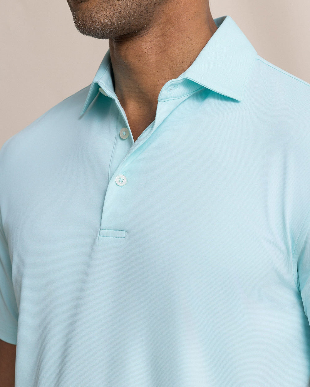 The detail view of the Southern Tide Coastal Breeze® Heather Performance Polo by Southern Tide - Heather Shore Blue