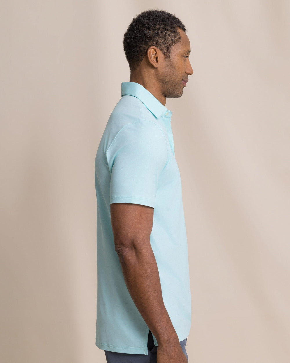 The side view of the Southern Tide Coastal Breeze® Heather Performance Polo by Southern Tide - Heather Shore Blue