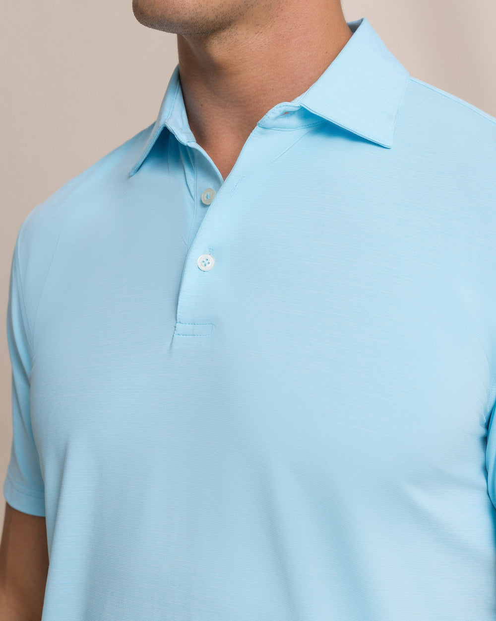 The detail view of the Southern Tide Coastal Breeze® Heather Performance Polo by Southern Tide - Heather Tropical Breeze Blue