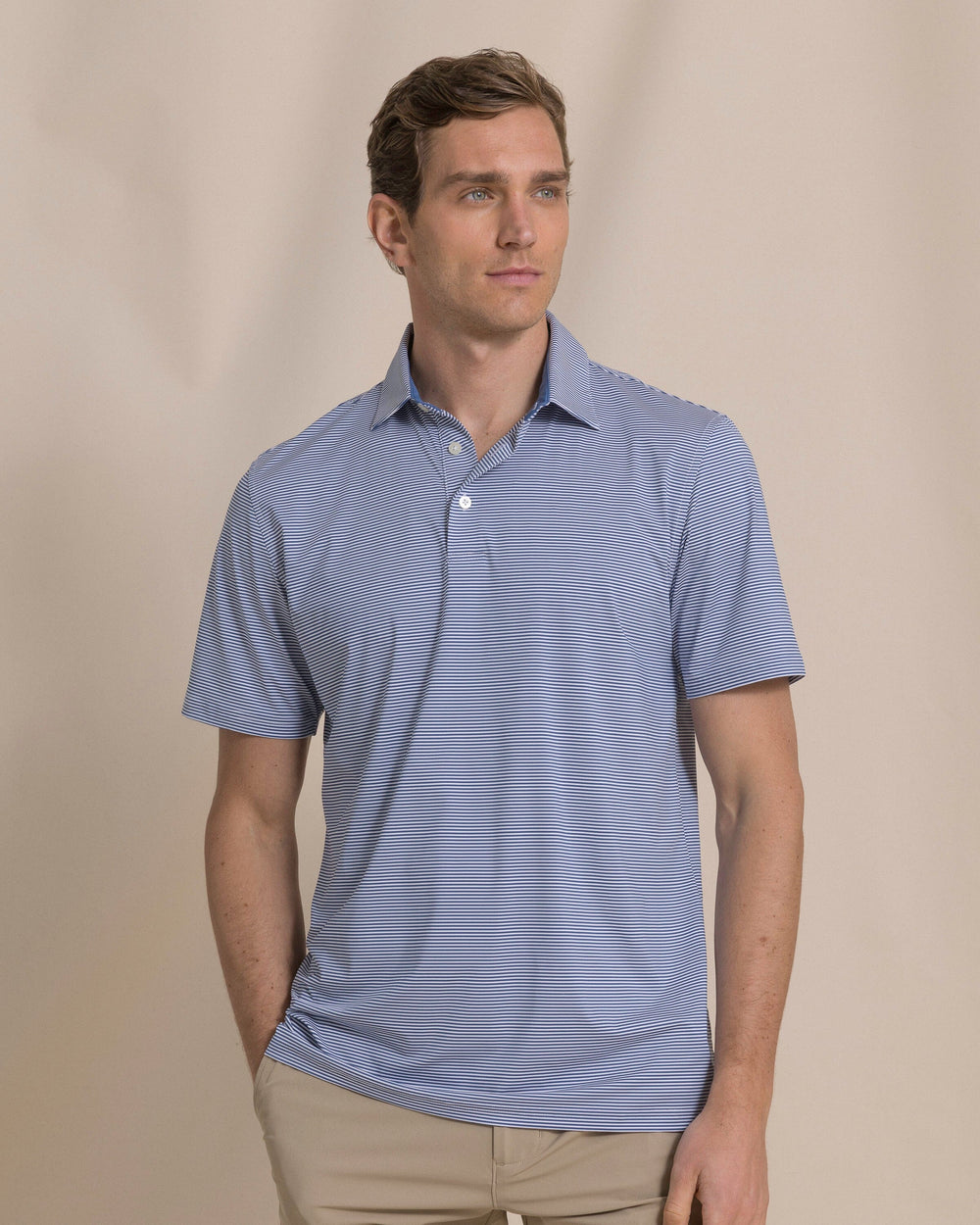 The front view of the Southern Tide Coastal Breeze® Meadowbrook Stripe Performance Polo by Southern Tide - Aged Denim