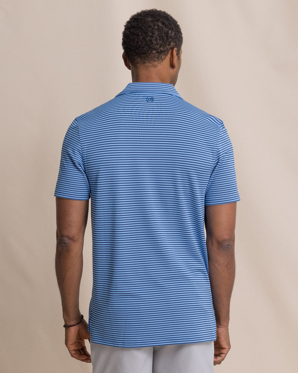 The back view of the Southern Tide Coastal Breeze® Oceanfront Stripe Pique Performance Polo by Southern Tide - Ocean Channel