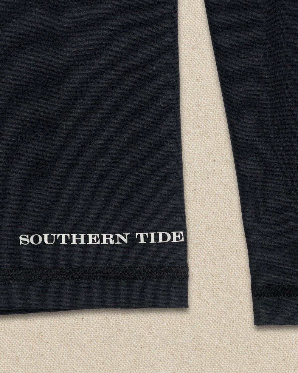 The detail view of the Southern Tide Coastal Breeze® Performance Hoodie by Southern Tide - Caviar Black