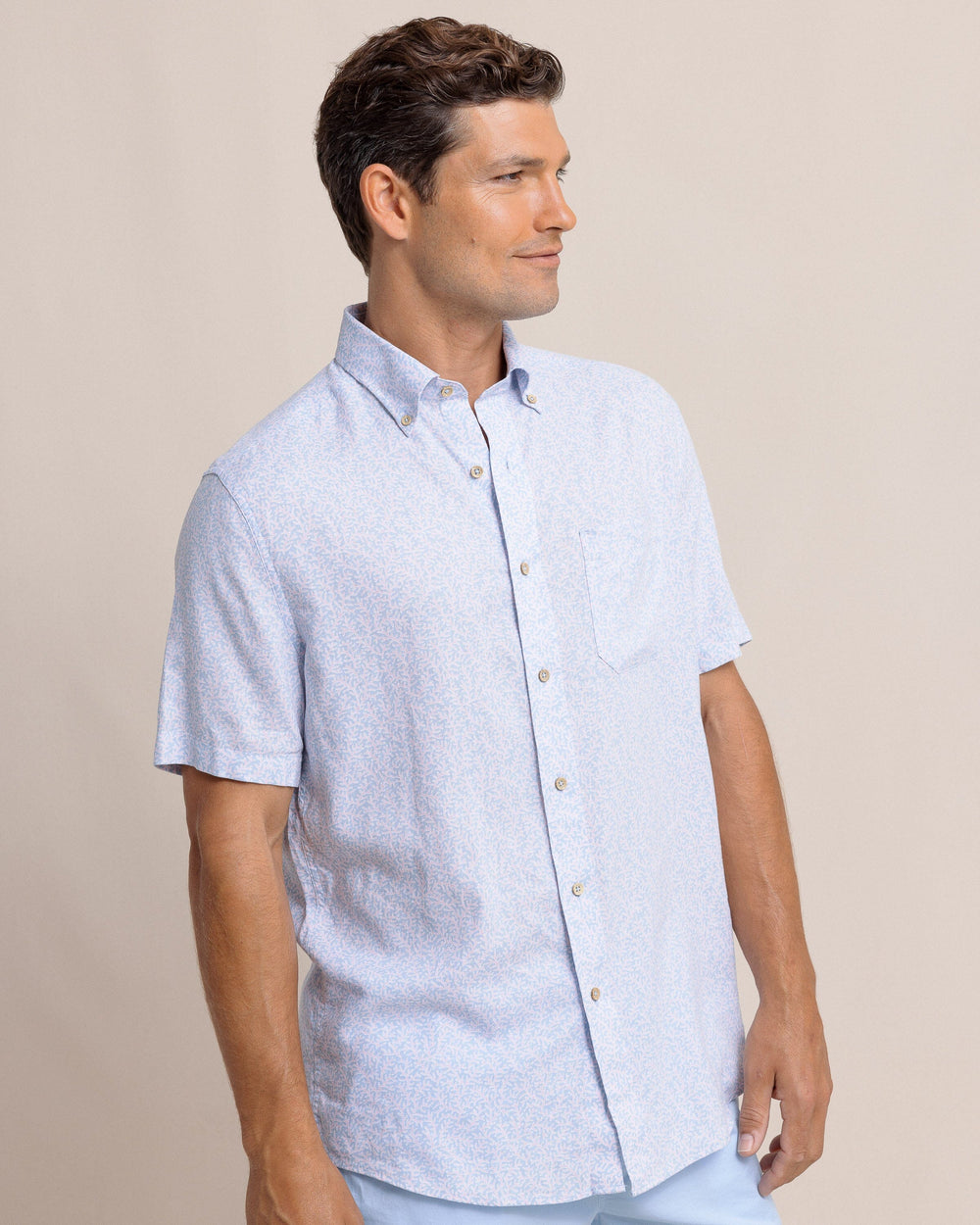 The side view of the Southern Tide Coral Life Linen Rayon Short Sleeve Sport Shirt by Southern Tide - Cerulean