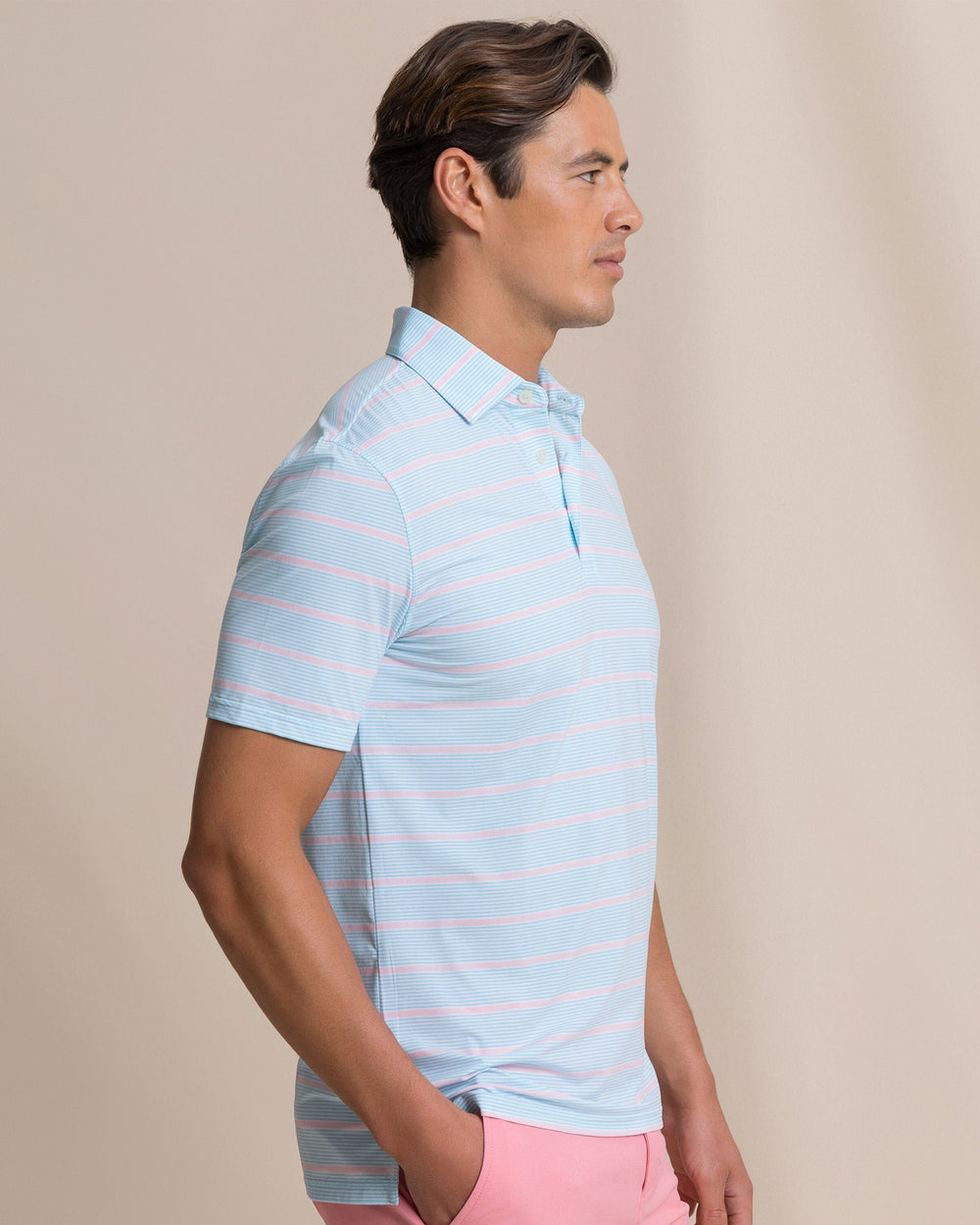 The side view of the Southern Tide Core Sound Stripe Coastal Breeze® Performance Polo by Southern Tide - Tropical Breeze Blue