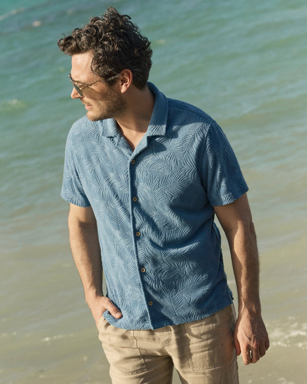 The lifestyle view of the Southern Tide Crystal Beach Terry Short Sleeve Camp Short by Southern Tide - Coronet Blue