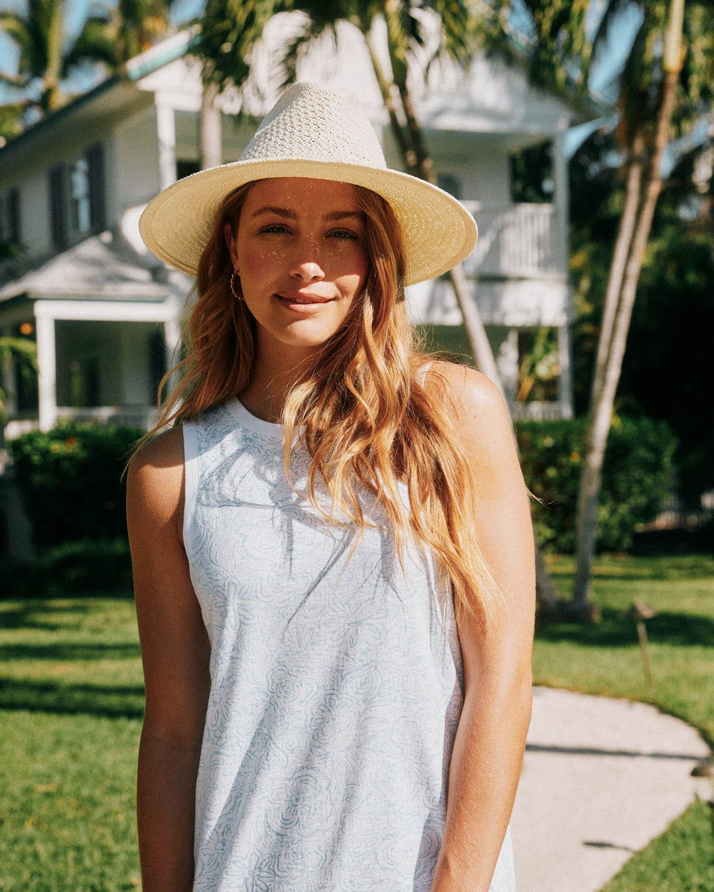 The lifestyle view of the Southern Tide Delaney Forever Floral Sun Farer Tank Dress by Southern Tide - Sky Blue