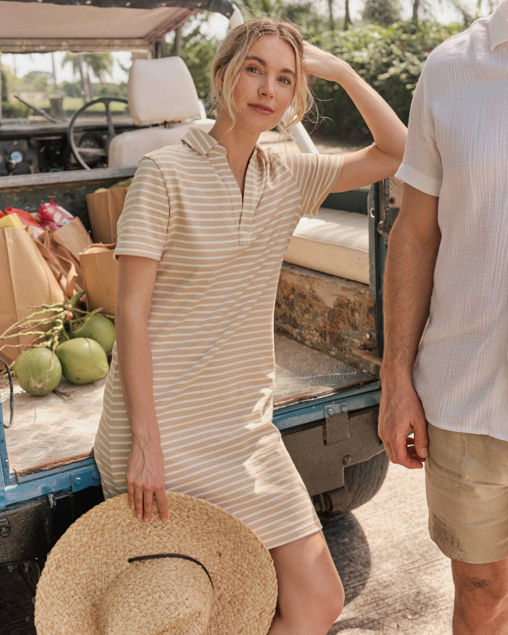 The lifestyle view of the Southern Tide Demi Short Sleeve Polo Dress by Southern Tide - Irish Cream
