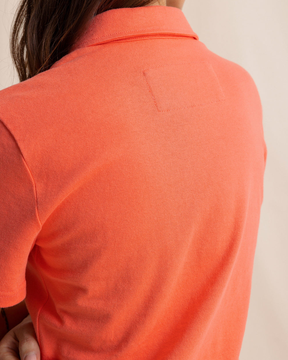 The back detail view of the Southern Tide Demi Solid Short Sleeve Polo Dress by Southern Tide - Sunset Coral