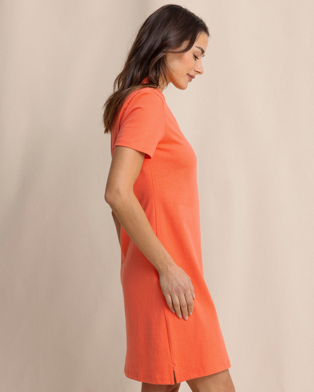 The side view of the Southern Tide Demi Solid Short Sleeve Polo Dress by Southern Tide - Sunset Coral