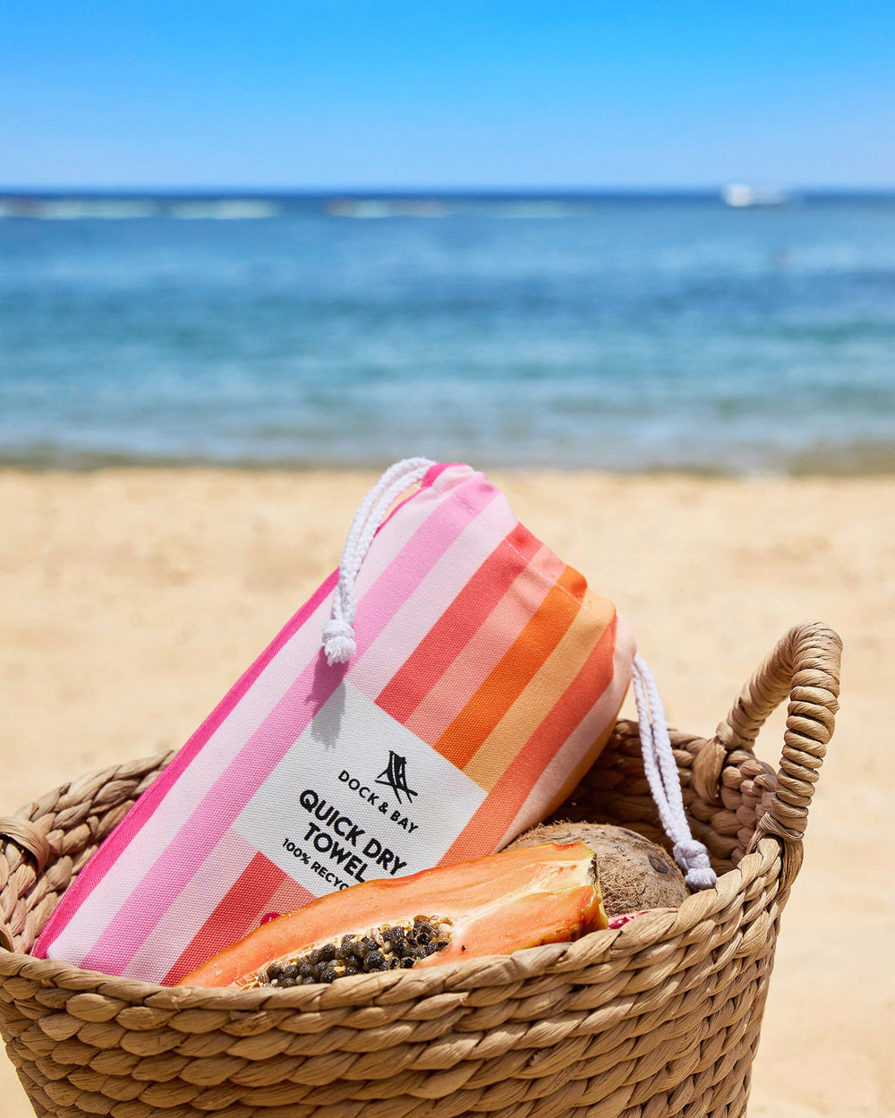 The lifestyle view of the Southern Tide Dock & Bay Quick Dry Beach Towel by Southern Tide - Miami Sorbet Pink