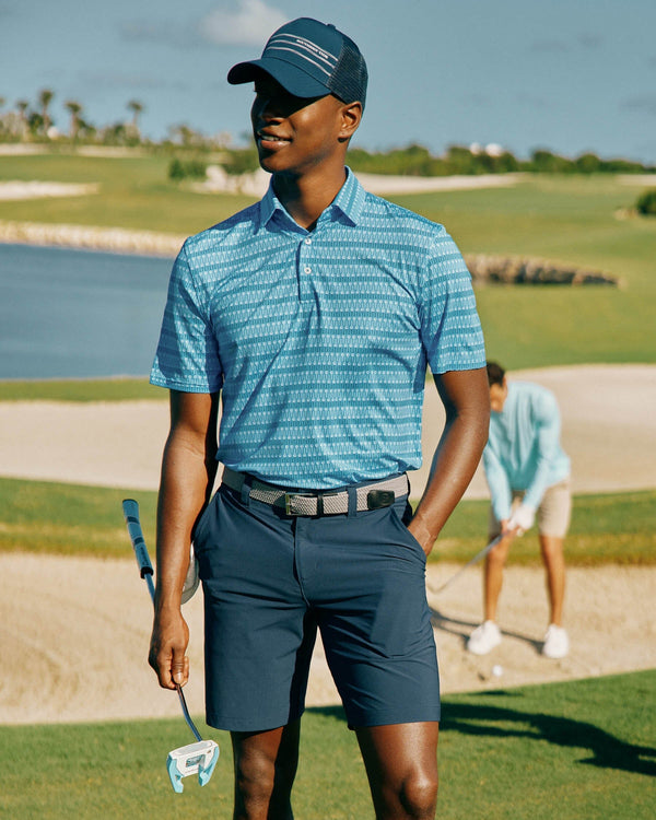 The Lifestyle view of the Southern Tide Driver Best Ball Print Performance Polo Shirt by Southern Tide - Boat Blue