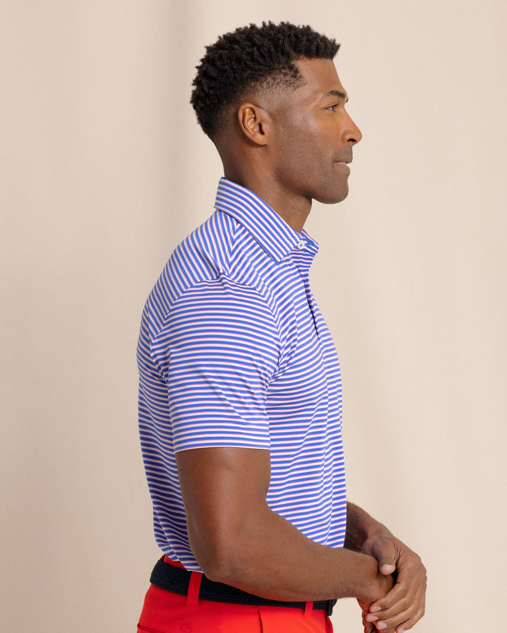 The side view of the Southern Tide Driver Caravel Stripe Polo by Southern Tide - Dazzling Blue