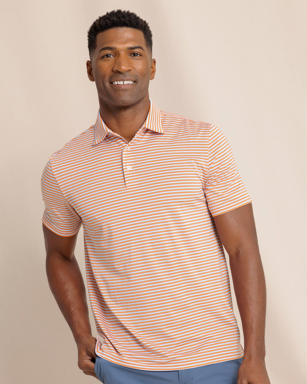 The front view of the Southern Tide Driver Caravel Stripe Polo by Southern Tide - Peach Parfait