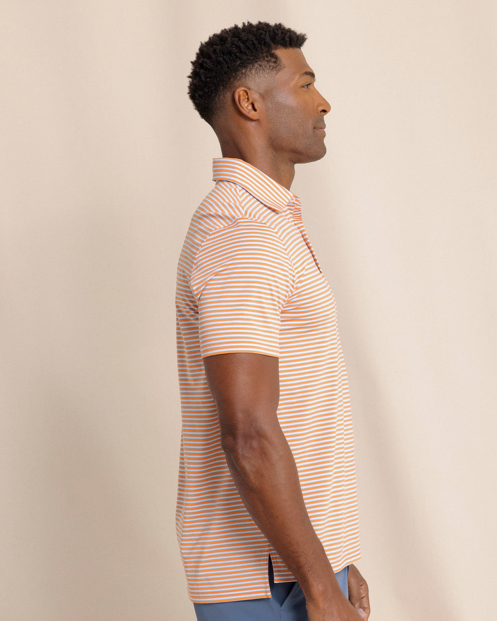The side view of the Southern Tide Driver Caravel Stripe Polo by Southern Tide - Peach Parfait