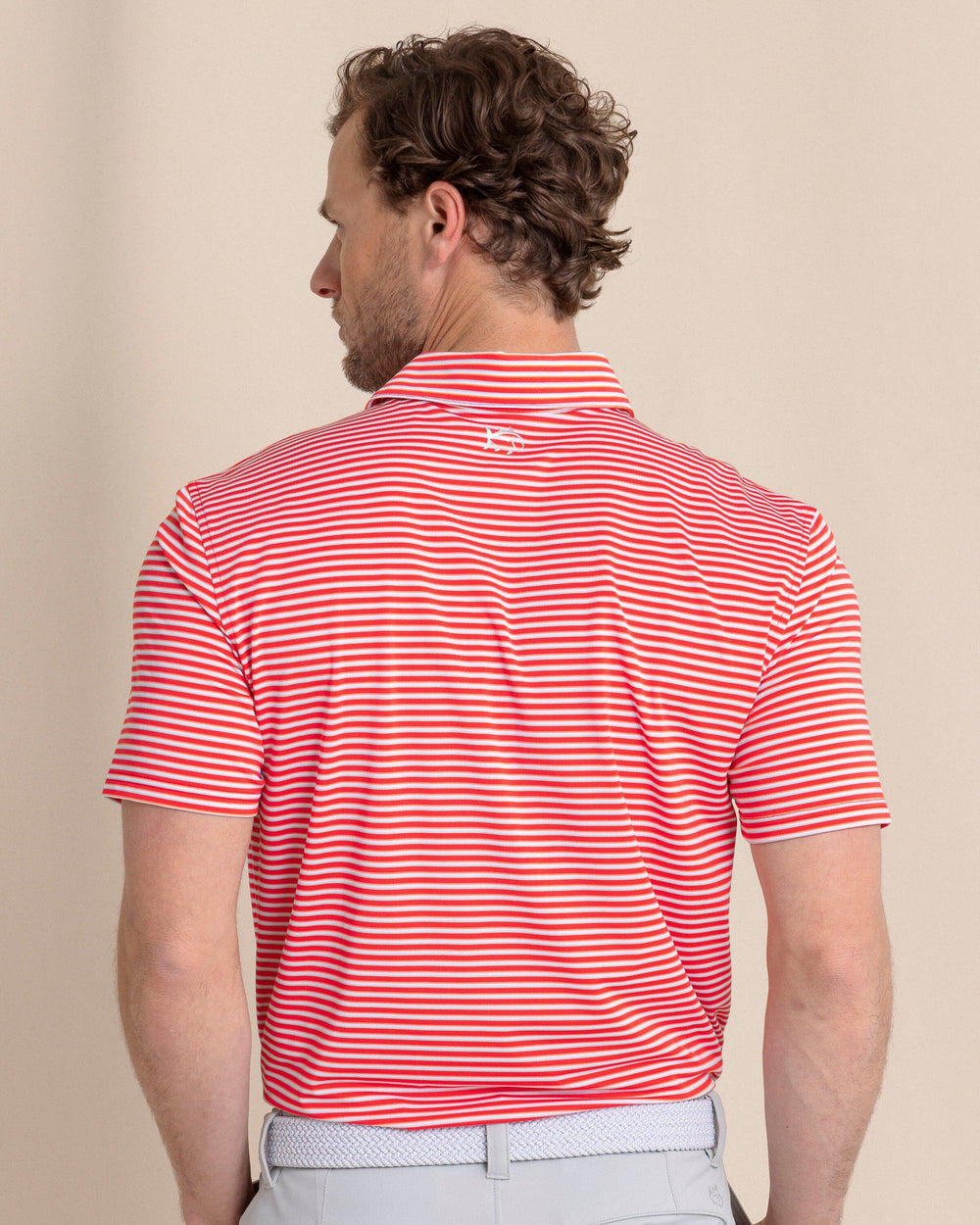 The back view of the Southern Tide Driver Caravel Stripe Polo by Southern Tide - Poppy Red