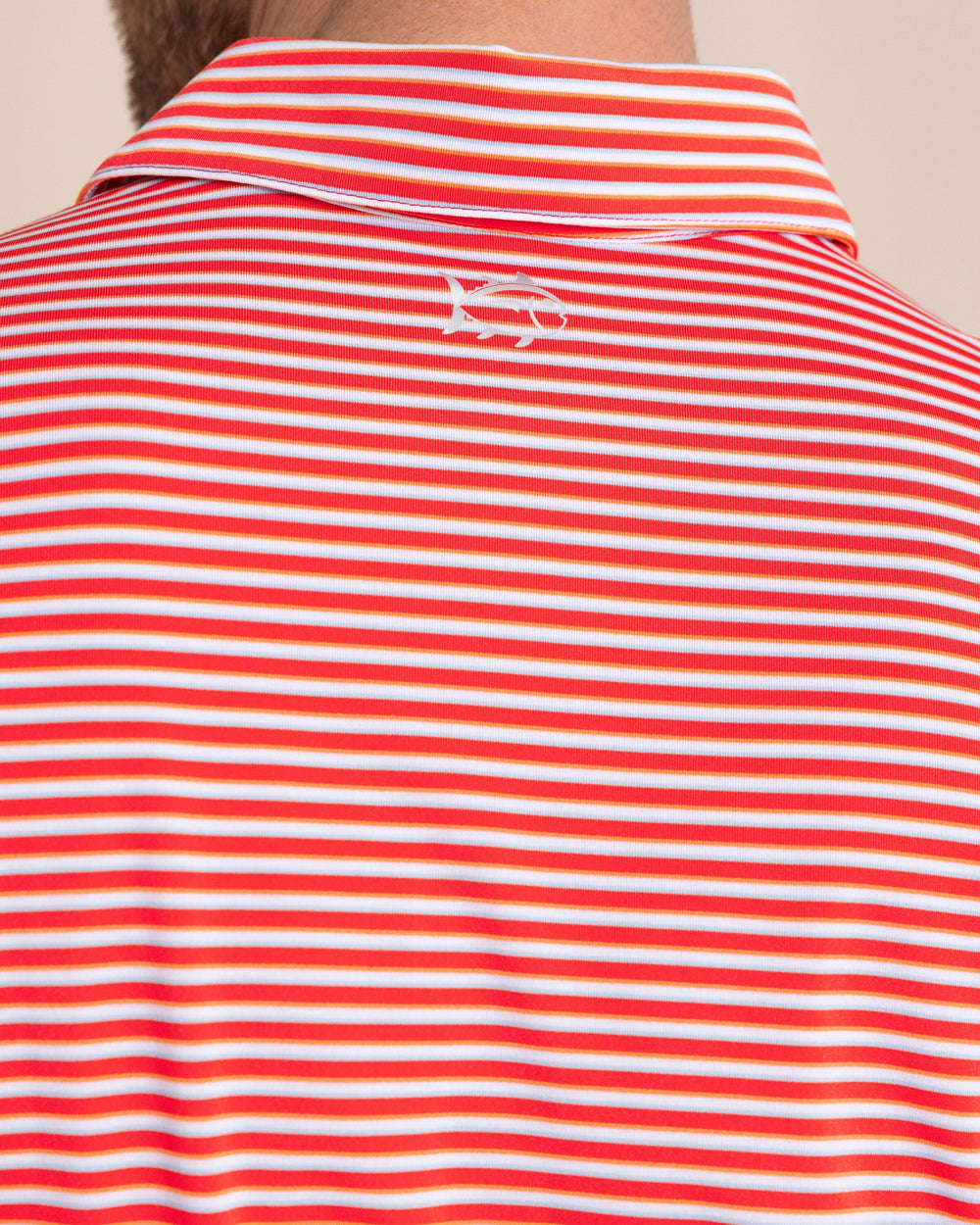 The back detail view of the Southern Tide Driver Caravel Stripe Polo by Southern Tide - Poppy Red