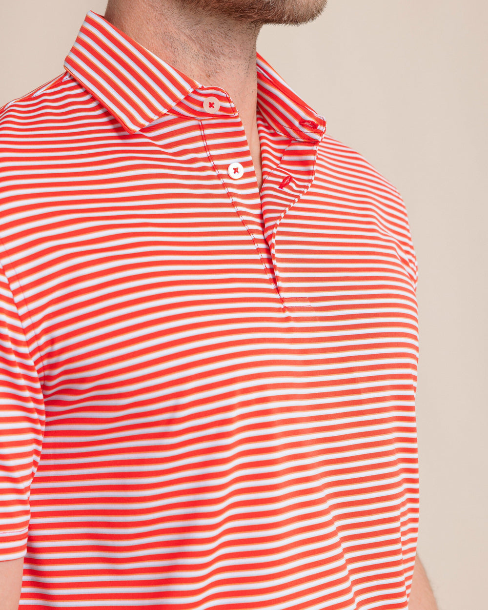 The front detail view of the Southern Tide Driver Caravel Stripe Polo by Southern Tide - Poppy Red