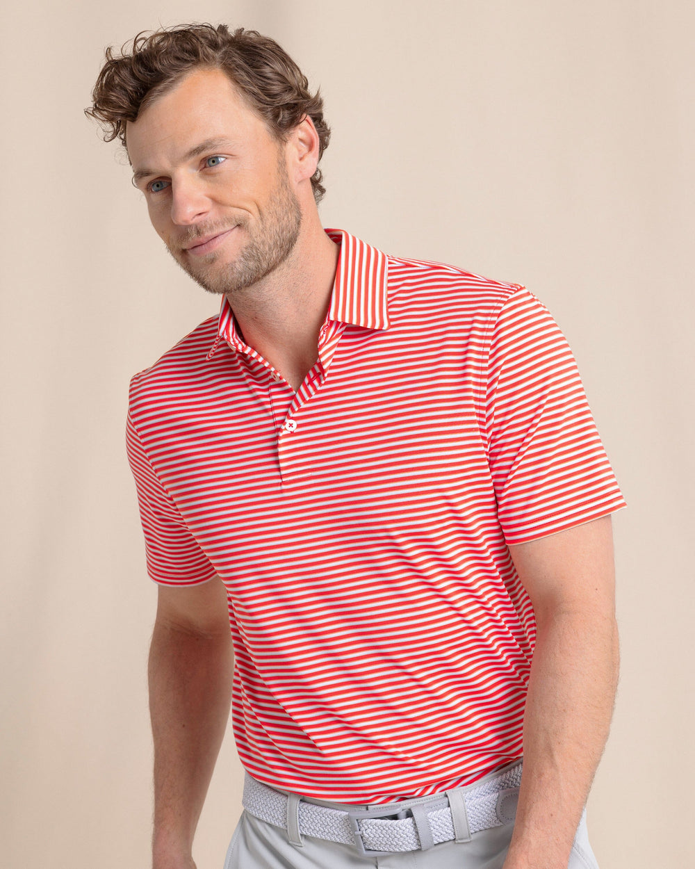 The front side view of the Southern Tide Driver Caravel Stripe Polo by Southern Tide - Poppy Red