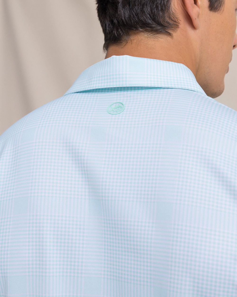 The detail view of the Southern Tide Driver Coral Key Plaid Printed Polo by Southern Tide - Gulf Shores