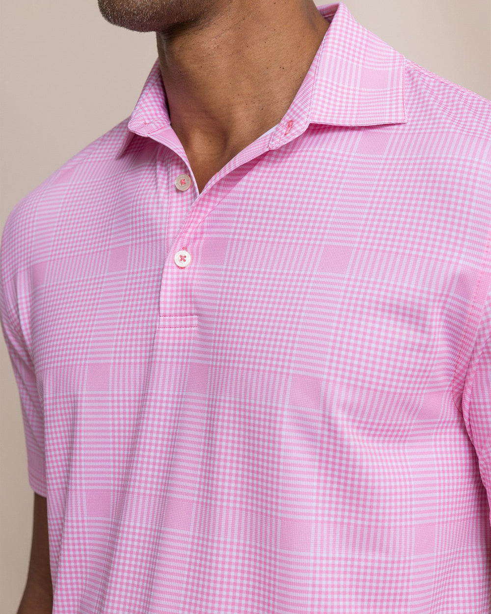 The detail view of the Southern Tide Driver Coral Key Plaid Printed Polo by Southern Tide - Sea Pink