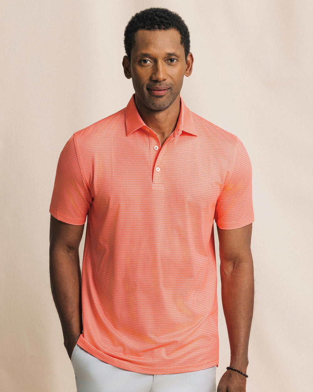 The front view of the Southern Tide Driver Getting Ziggy With It Printed Polo by Southern Tide - Orange Blossom
