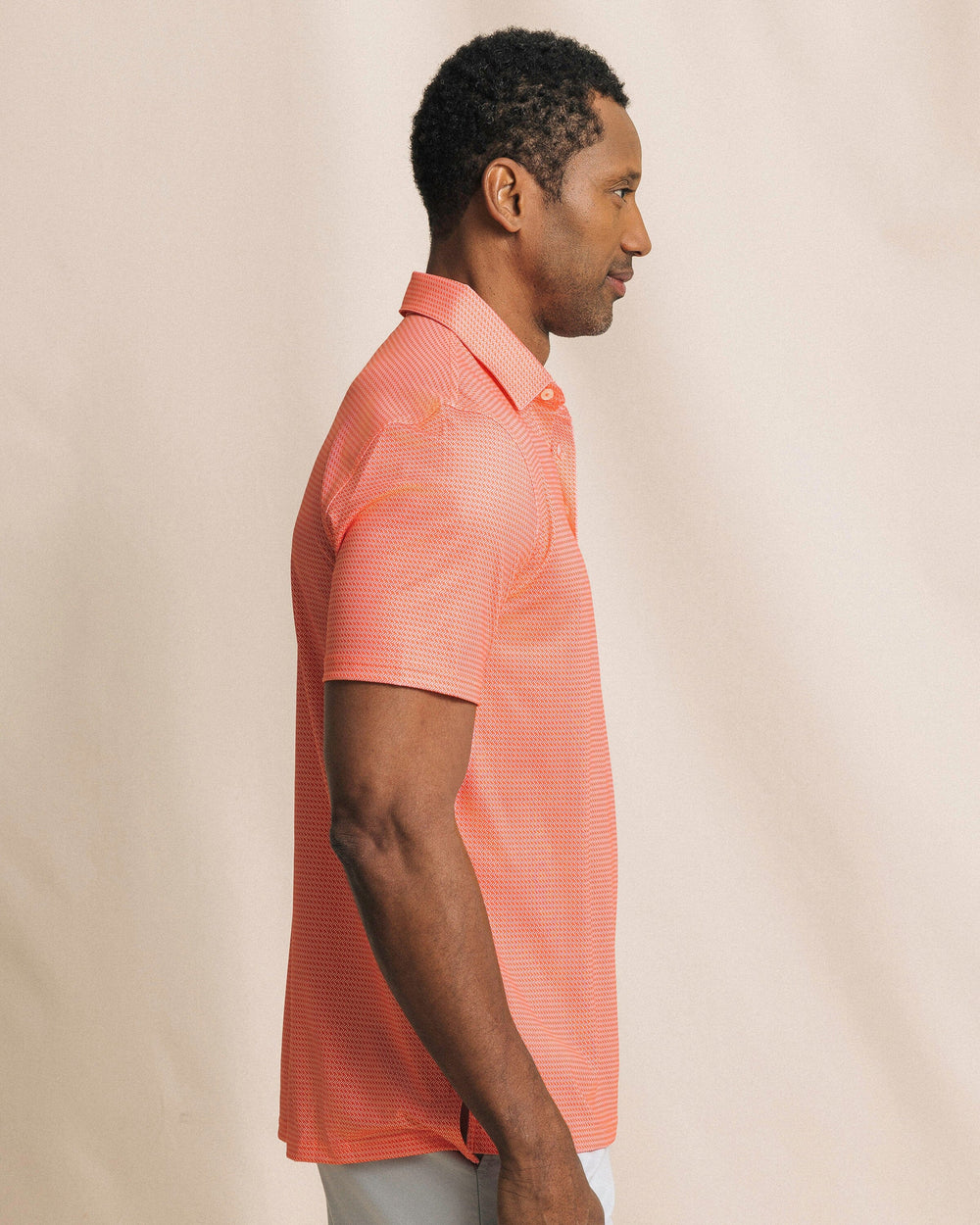 The side view of the Southern Tide Driver Getting Ziggy With It Printed Polo by Southern Tide - Orange Blossom