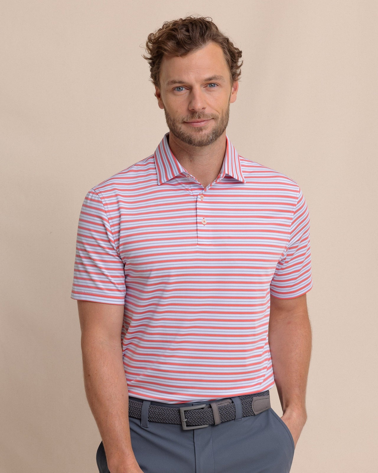 The front view of the Southern Tide Driver Ocean Hill Stripe Polo by Southern Tide - Sunkist Coral