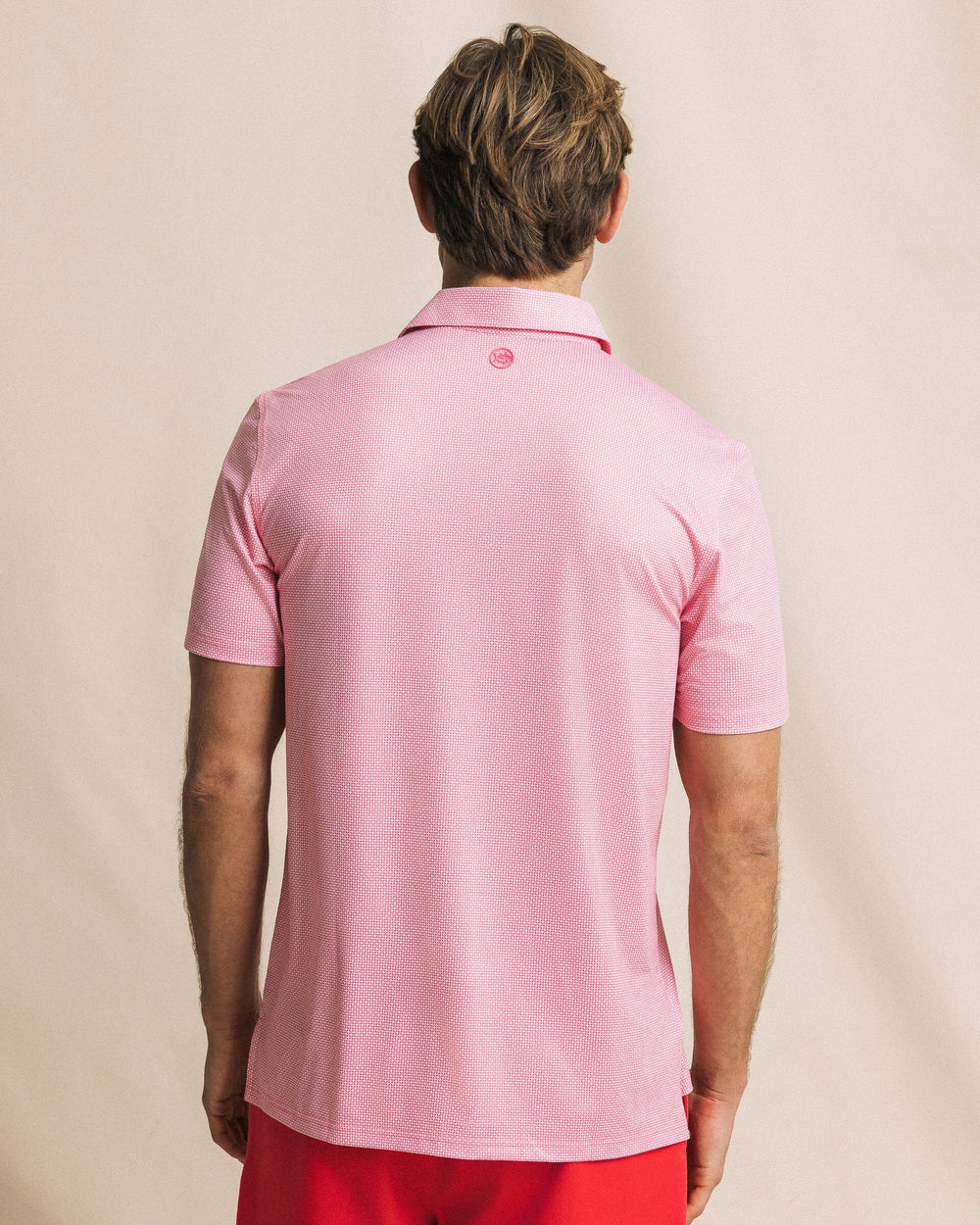 The back view of the Southern Tide Driver Ocean Vista Printed Polo by Southern Tide - Island Pink