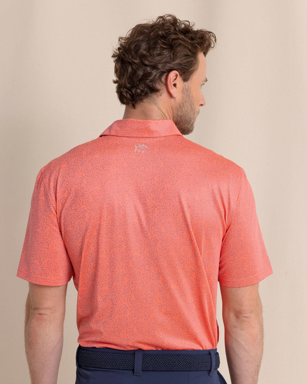 The back view of the Southern Tide Driver Pineapple Paradise Printed Polo by Southern Tide - Sunset Coral