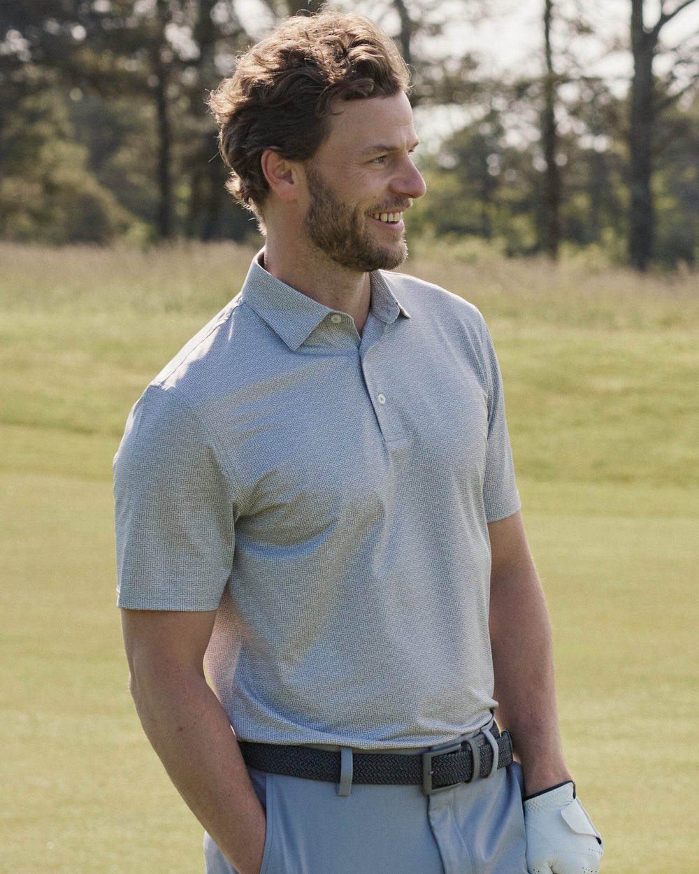 The lifestyle view of the Southern Tide Driver ST Geo Printed Polo by Southern Tide - Steel